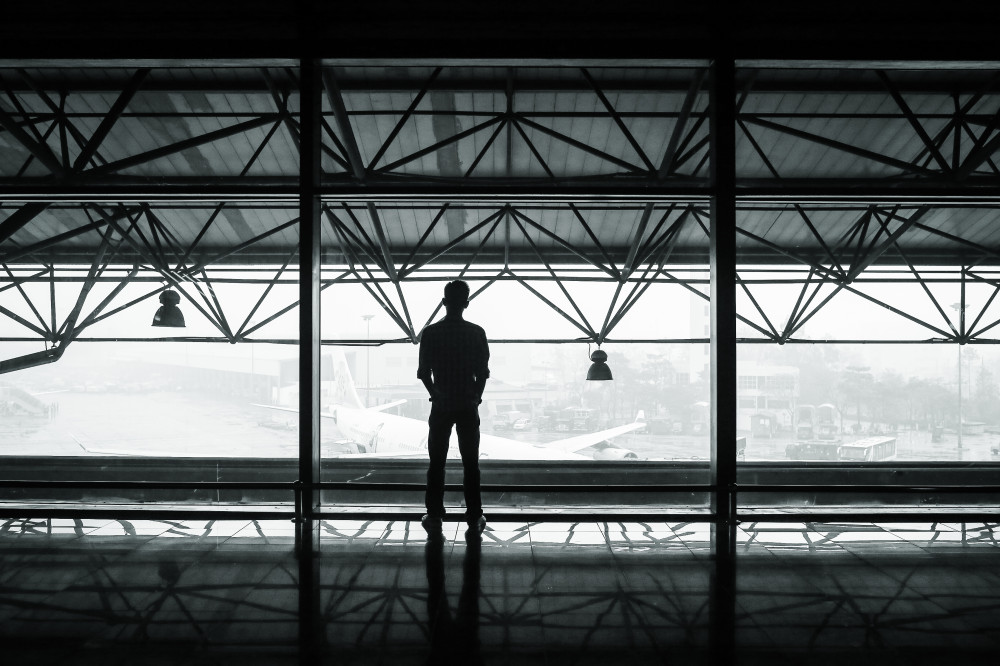 Public Domain Images – .com – Airport Plane Hanger Man Standing Back Foggy Mist Architecture