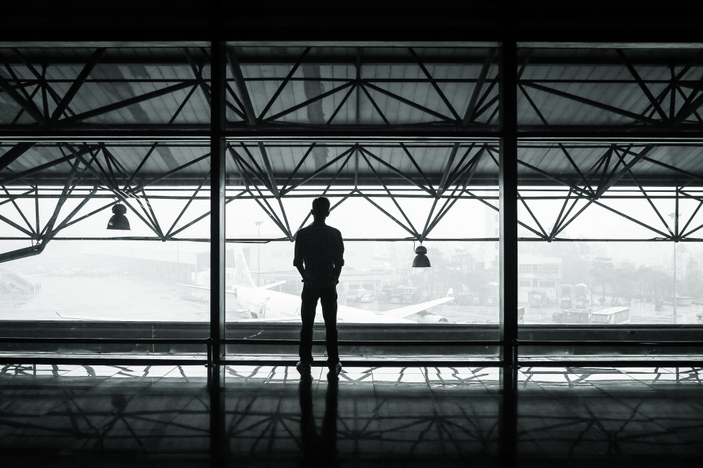 Public Domain Images - .com - Airport Plane Hanger Man Standing Back Foggy Mist Architecture